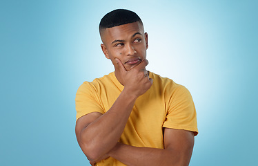 Image showing Man, face and thinking in decision, choice or planning for idea or memory against a blue studio background. Unsure male person or curious model in wonder, remember or solution in why, emoji or mockup