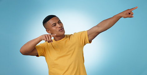 Image showing Pointing, announcement or man by offer, discount deal or sale on studio space or advertising. Breaking news, show or male person with mockup for guide, menu choice or promotion on blue background