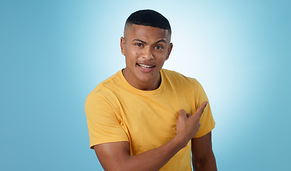 Image showing Pointing, question and portrait of man in a studio with mockup for marketing, advertising or promotion. Confused, thinking and young male person with a show hand gesture isolated by blue background.