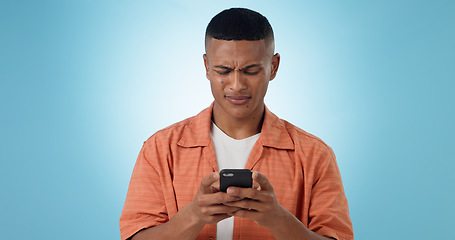 Image showing Doubt, confused and man with cellphone, typing and connection with digital app on blue background. Person, guy and model with smartphone, mobile user or reaction with expression, error 404 or contact