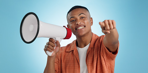 Image showing Man, megaphone and choice or pointing you for announcement, broadcast and vote or news on blue background. Portrait of person for join us, attention and voice with sale, bonus or winning in studio