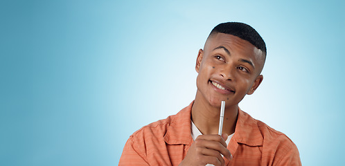 Image showing Thinking, pen and man in studio with idea, solution or problem solving on blue background space. Questions, face or male university student with brainstorming emoji for solution, answer or conclusion