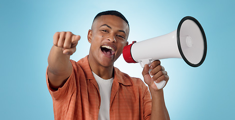 Image showing Man, megaphone and winner or pointing you for announcement, broadcast and choice or news on blue background. Portrait of person for join us, attention and voice with sale, bonus or winning in studio