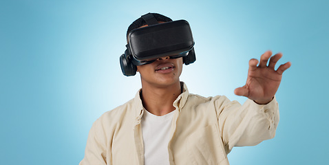 Image showing Man, student and VR or futuristic glasses for e learning, 3d software and user experience on blue background. Person with virtual reality vision, education and metaverse technology or games in studio