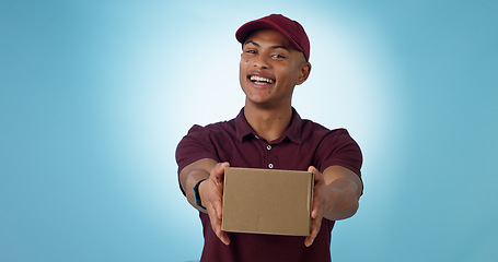Image showing Portrait, happy man and courier with delivery in studio for mock up on blue background in Cape Town. Male model, smile and excited for logistics, shipping or distribution of package, parcel or order