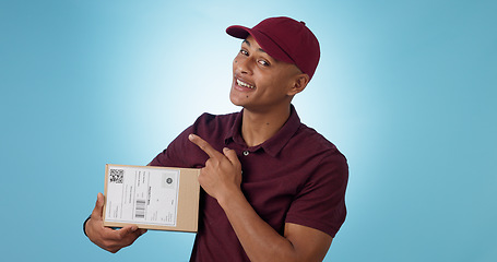 Image showing Portrait, happy man and courier for pointing in studio with mock up for announcement on blue background. Cape Town, male model and smile for presentation of alert, promotion or notification in space