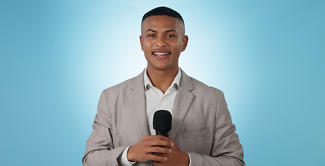 Image showing Man, news or reporter with mic on blue background for mock up of broadcast in studio in Cape Town. Portrait, male model and happy with smile for journalism, announcement or information by live stream