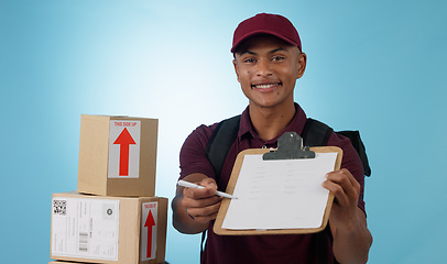 Image showing Delivery man, boxes and document for signature, distribution or courier service checklist on a blue background. Portrait of logistics worker with package and receipt or clipboard paperwork in studio