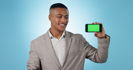 Image showing Business man, phone green screen and presentation, advertising information or trading software in studio. Happy, professional and trader with mobile app or space, tracking markers and blue background