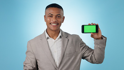 Image showing Business man, phone green screen and portrait for presentation, advertising information or trading software in studio. Happy, face and young trader on mobile app, tracking markers and blue background