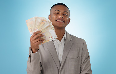 Image showing Business man, winner and money fan for success, bonus and winning in a competition, loan or cashback in studio. Portrait of young worker with cash, reward or financial savings on a blue background