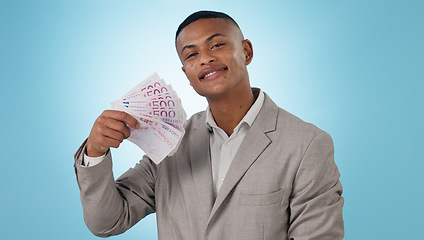 Image showing Business man, winning and money fan for success, bonus and lottery prize, stock market profit or cashback in studio. Portrait of winner or trader cash and financial achievement on a blue background