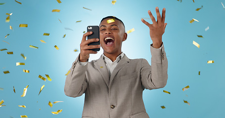Image showing Business man, phone and winning with confetti celebration, stock market news or competition winner in studio. Young trader in wow, surprise and excited for profit or sale on mobile on blue background