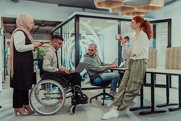 Image showing Young group of business people brainstorming together in a startup space, discussing business projects, investments, and solving challenges.