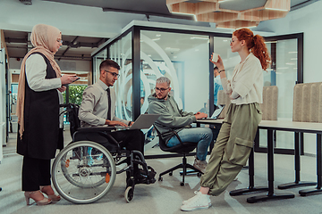 Image showing Young group of business people brainstorming together in a startup space, discussing business projects, investments, and solving challenges.