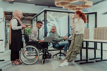 Image showing Young group of business people brainstorming together in a startup space, discussing business projects, investments, and solving challenges.