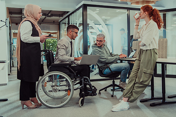 Image showing Young group of business people brainstorming together in a startup space, discussing business projects, investments, and solving challenges.