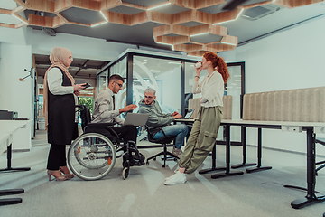 Image showing Young group of business people brainstorming together in a startup space, discussing business projects, investments, and solving challenges.