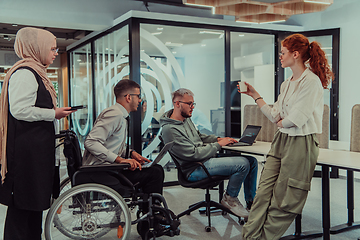 Image showing Young group of business people brainstorming together in a startup space, discussing business projects, investments, and solving challenges.