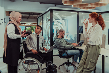 Image showing Young group of business people brainstorming together in a startup space, discussing business projects, investments, and solving challenges.