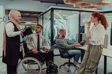 Image showing Young group of business people brainstorming together in a startup space, discussing business projects, investments, and solving challenges.