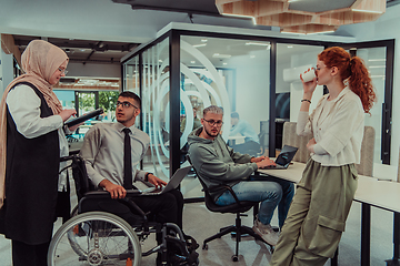 Image showing Young group of business people brainstorming together in a startup space, discussing business projects, investments, and solving challenges.