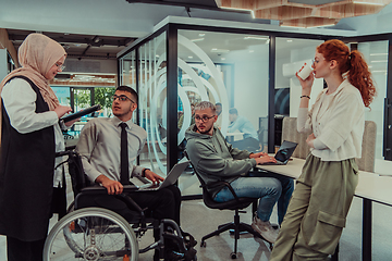 Image showing Young group of business people brainstorming together in a startup space, discussing business projects, investments, and solving challenges.