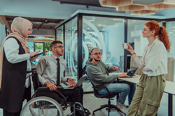 Image showing Young group of business people brainstorming together in a startup space, discussing business projects, investments, and solving challenges.