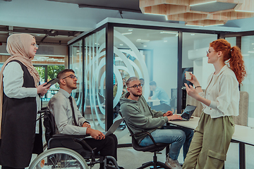 Image showing Young group of business people brainstorming together in a startup space, discussing business projects, investments, and solving challenges.