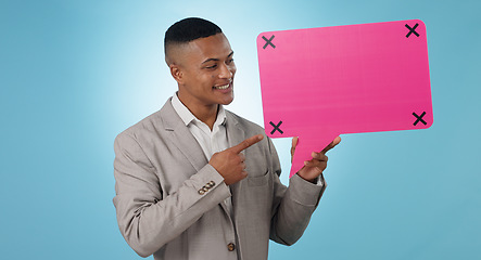 Image showing Business man, speech bubble and presentation of chat poster, social media quote or communication in studio. Young worker pointing to FAQ mockup, career forum and tracking markers on a blue background