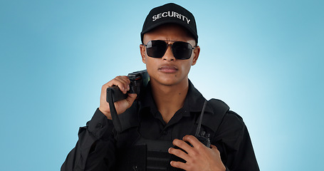 Image showing Portrait, security guard and serious man in sunglasses, safety protection service or law enforcement. Face, cop and police officer for justice, danger or crime in studio isolated on a blue background