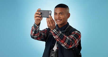 Image showing Hiking, man and cellphone with social media, photography and profile picture on a studio background. Person, traveller and model with a smartphone, travel and post with blog, tourism and adventure