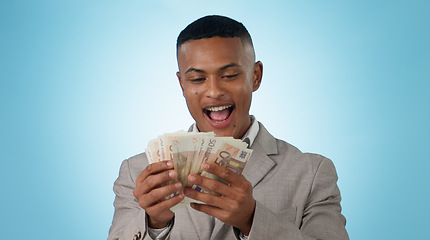 Image showing Business man, wow and money for winning, success and lottery prize, bonus or stock market profit in studio. Excited winner or young trader with cashback and surprise for savings on a blue background