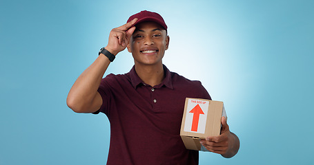 Image showing Happy man, shipping box or portrait of delivery guy in studio with courier service or supply chain package. Smile, blue background or worker greeting distribution, online shopping or post services