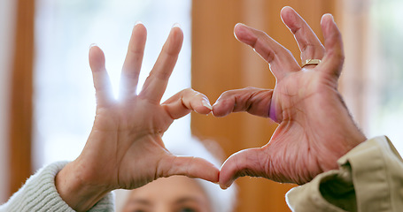 Image showing Closeup, home and senior couple with heart hands, support and romance with retirement, relationship and care. Apartment, elderly man and old woman with symbol for love, marriage and romantic with joy