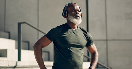 Image showing Mature, black man and exercise with headphones for fitness, workout and runner rest for breathing outdoor on stairs. Thinking, training and athlete listening to music, podcast or radio for motivation