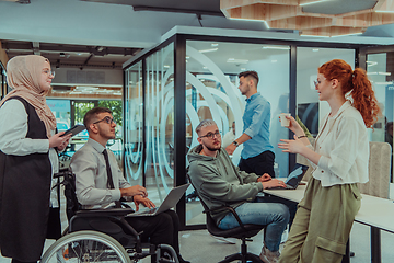 Image showing Young group of business people brainstorming together in a startup space, discussing business projects, investments, and solving challenges.