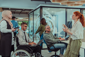 Image showing Young group of business people brainstorming together in a startup space, discussing business projects, investments, and solving challenges.