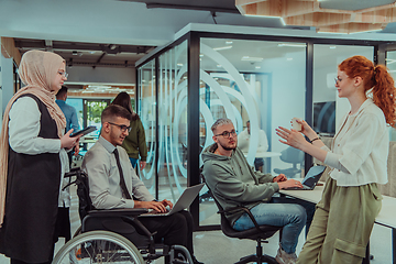 Image showing Young group of business people brainstorming together in a startup space, discussing business projects, investments, and solving challenges.