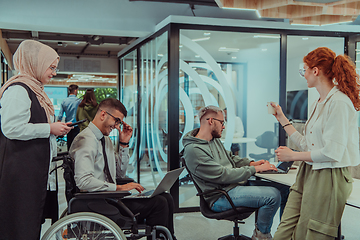 Image showing Young group of business people brainstorming together in a startup space, discussing business projects, investments, and solving challenges.