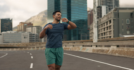 Image showing Time, fitness and a man running in the city for sports training, getting ready for a marathon or race. Watch, exercise and a young runner or athlete outdoor in an urban town for his workout routine