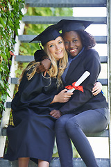 Image showing Graduation, college and women or friends hug for education achievement, success and celebration of diploma. Portrait of students in diversity with law certificate, university campus by stairs