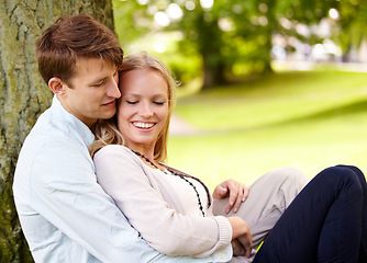 Image showing Nature, relax and happy couple hug, love and cuddle in outdoor park, green garden or grass field, pitch or lawn. Summer freedom, support and romantic man, woman or marriage people hugging on ground