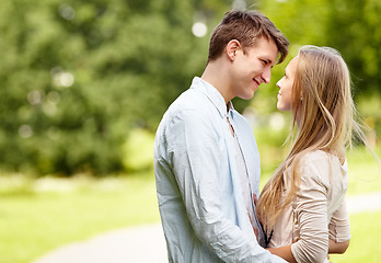 Image showing Park, eye contact and happy couple hug, love and bonding in outdoor nature, green garden or romantic date. Happiness, wellness and spring man, woman or marriage people embrace for relationship care