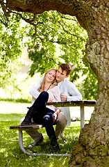 Image showing Park, bench or happy couple hug, love and bonding in outdoor nature, green garden or romantic date. Summer sunshine, tree shade or relax boyfriend, girlfriend or partner embrace for relationship care