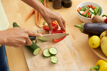 Image showing Closeup, hands and cutting with vegetables, nutrition and plant based diet in a kitchen. Person, home and cooking health food, lunch and vegan meal with variety, vitality and weight loss with knife