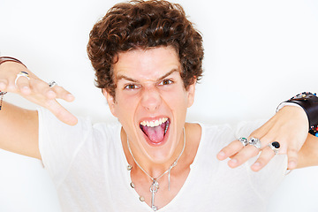 Image showing Portrait, energy and crazy with a man in studio isolated on a white background for the expression of emotion. Face, fashion and freedom with an edgy young model looking wild or fierce rockstar style