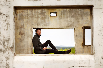 Image showing Man, frame and travel by ruin house, relax and chilling by remains of building, smile and portrait. Happy male person, historic site and vacation for culture, history and tourism in Machu Picchu