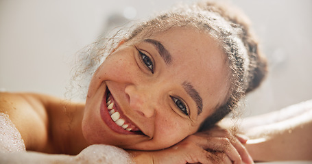 Image showing Health, smile and face of a woman in the bath at her home for zen, calm or self care routine. Happy, peace and headshot portrait of young female person relaxing in a tub in the bathroom in apartment.