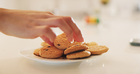 Image showing Hands, cookies and plate on table in home kitchen, eating or hungry for sweets at breakfast. Closeup, biscuits and sugar food of person, dessert or confectionery snack for unhealthy diet in nutrition
